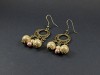 Boucles d'oreilles couleur bronze avec des perles magiques