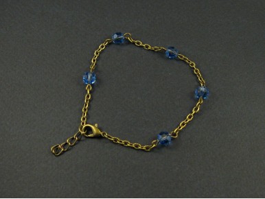 Bracelet fantaisie couleur bronze avec des perles de verre facettées bleues
